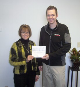 Debbie Laird, Janus Developmental Services vice presidentof development and transportation, accepts a check from
Brian Peterson, branch manager of W.W. Grainger in Indianapolis.
(Photo submitted)