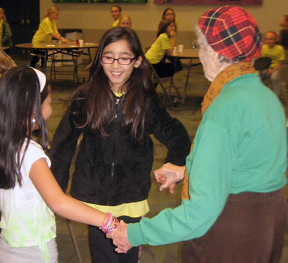 Oak Trace Elementary students Claire Davis and Grace Stewart dance with a Sanders Glen resident. (Photo provided by Tenna Pershing)