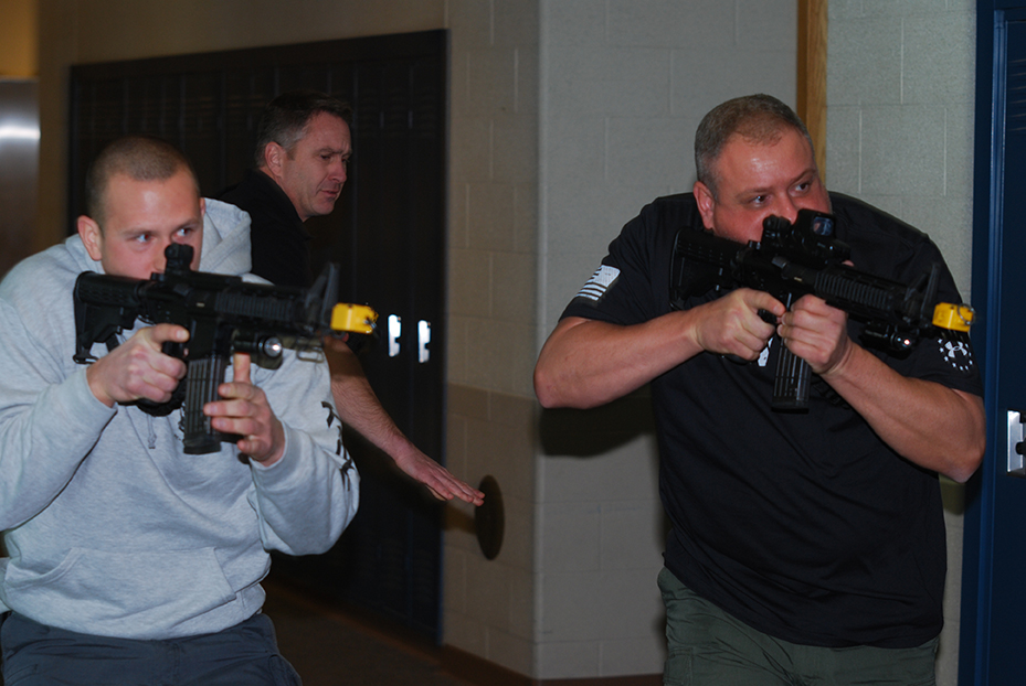 Westfield Police Officer Tony Howard, right, and Police Chief Joel Rush walk down a Westfield High School hallway in search of the threat during an active shooter demonstration to teachers.