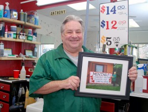 Tony Laurenzana holds of photo a customer took of him at the old shop.