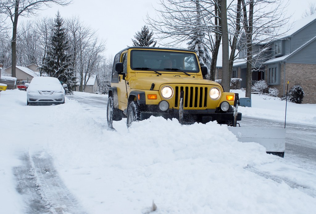 Westfield Mayor Andy Cook takes civic service to the next level as he drives his Jeep and plow through city streets helping to clear snow in the morning hours of March 6. (Photos by Robert Herrington)