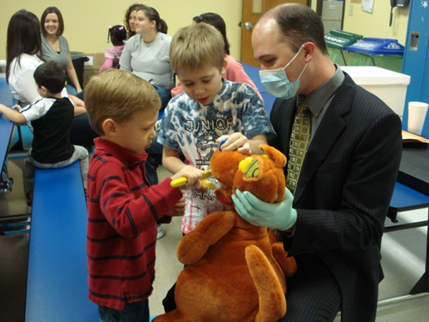 Dr. Kevin Beadle shows Little Star Learners healthy toothbrush habits. (Submitted photo)