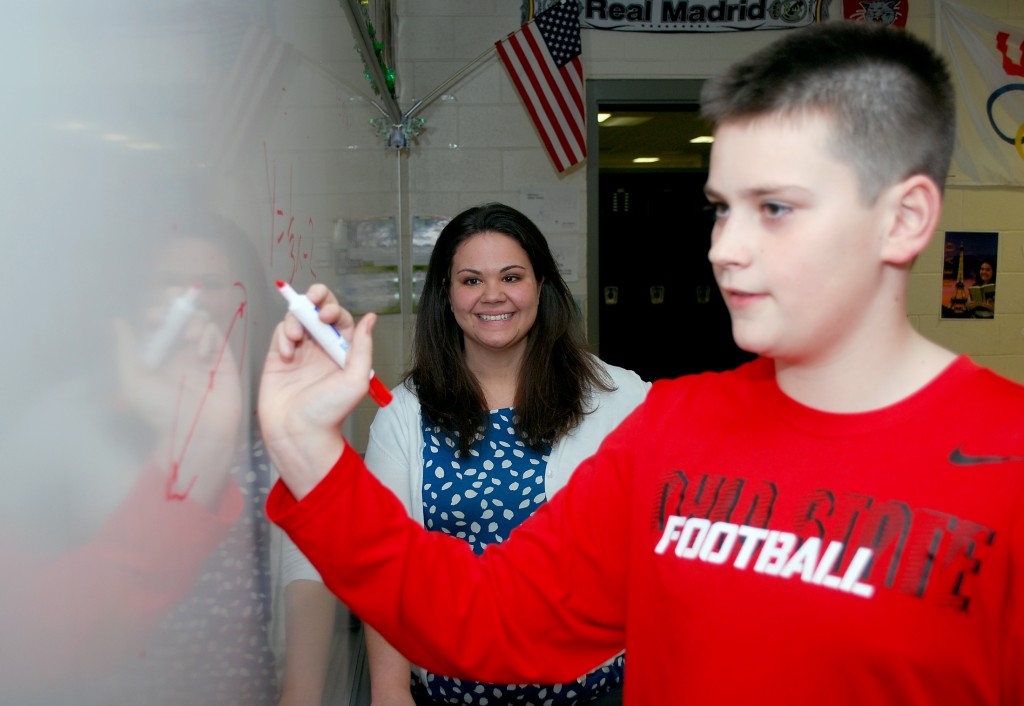 Kelly Day watches as seventh-grade student Michael Koza works on a math equation.
