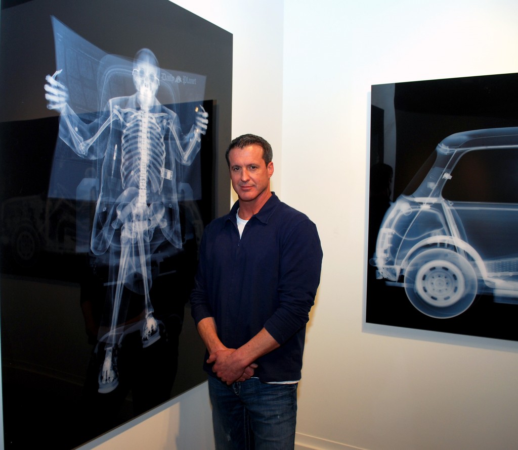 Evan Lurie, owner of Evan Lurie Fine Art Gallery, with pieces by artist Nick Veasey.