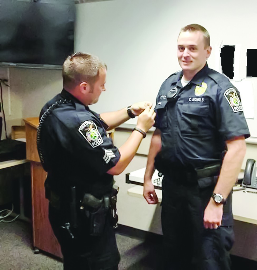 Officer Chuck Nichols, right, receives the Officer of the Month Award from Sgt. Billy Adams. (Photo provided)