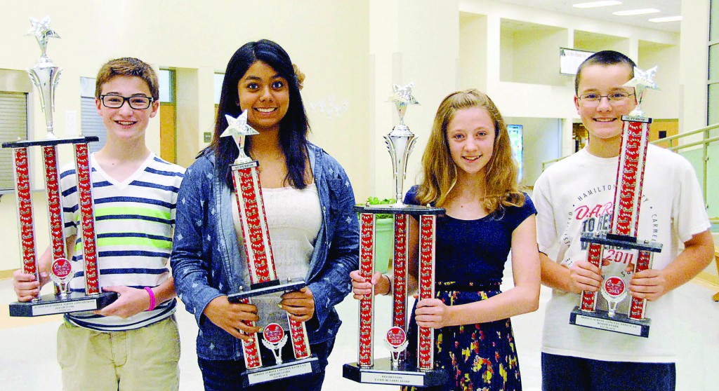 Grant Siefker and Savannah Seupaul proudly display the eighth-grade trophies while Sarah Pensyl holds the Esprit de Corps trophy and Dominic Duray displays the seventh-grade superior rating trophy. (Photo submitted)