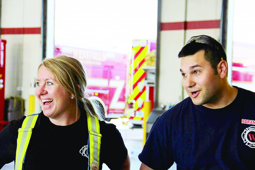 Amber Willis and Firefighter Paramedic Brad Shade chuckle after checking their equipment.