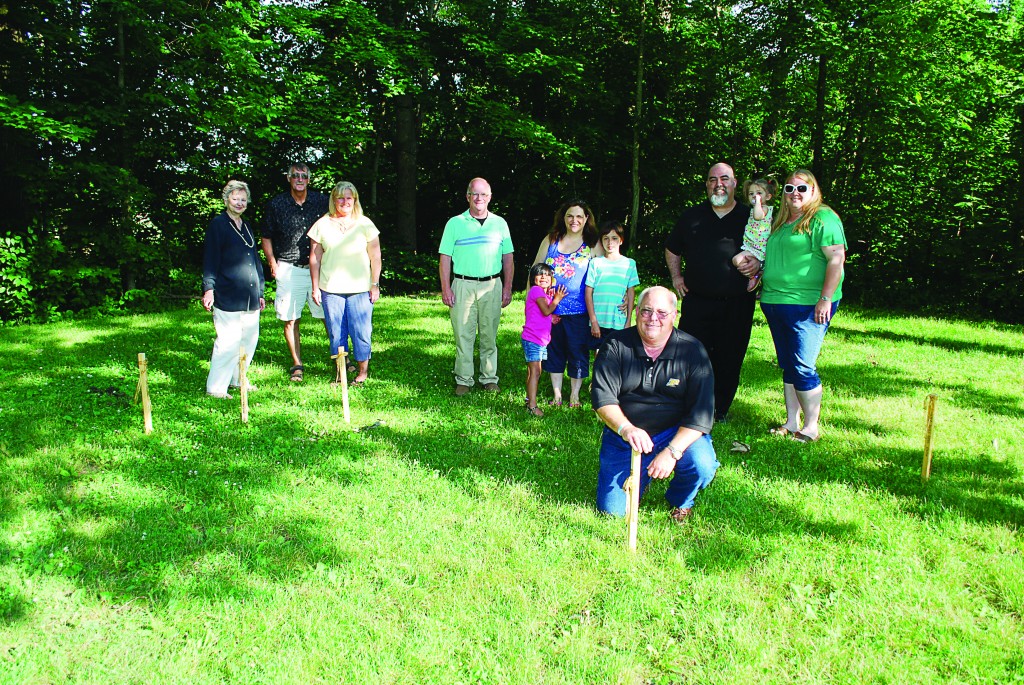 From left: Mary Sue Rowland, Bill and Sue Childs, Garry Warren, Ashley, Suzanne and Christian Brooks, Kirk Forbes and Jim, Madeline and Brandi Bates place temporary wooden stakes in the location of the Angel of Hope Memorial Garden to kick off its fundraising efforts. (Photos by Robert Herrington)
