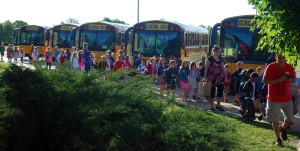 Students exit buses as they enter Carey Ridge Elementary School for the start of the 2013-14 school year this morning. (Photo by Robert Herrington)