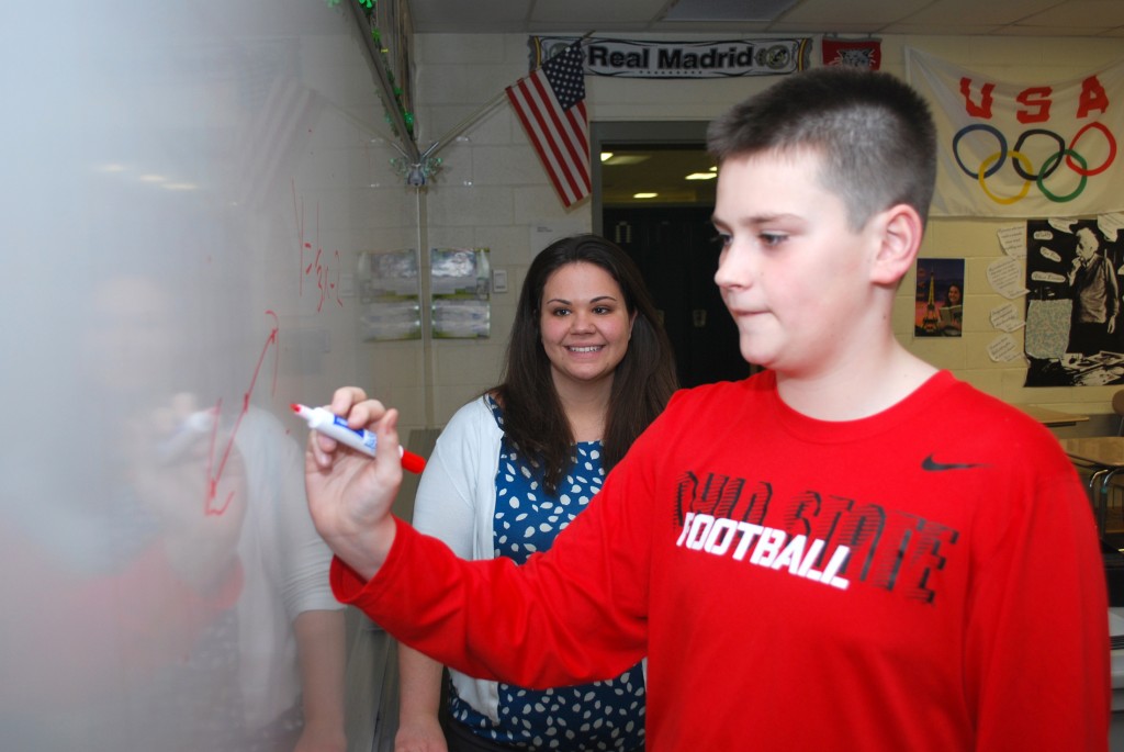 Westfield Middle School teacher Kelly Day watches as Michael Koza works out a math problem. (File photo by Robert Herrington)