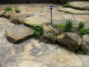 Marrying rock elements found around this Turkey Run home with a dramatic change in the landscape’s grade helped resolve both an aesthetic issue as well as a functional one. (Submitted photo)