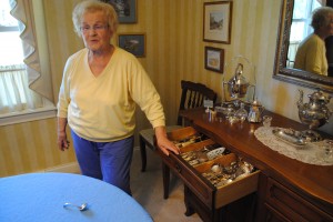 Doreen Squire Ficara, Carmel Arts Council executive director, displays some of the antique silverware that will be used in a fundraiser for arts scholarships. (Staff photo)