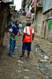 The slums in Nairobi have narrow main streets that also serve as a playground for the young, as well as an open sewage line. 