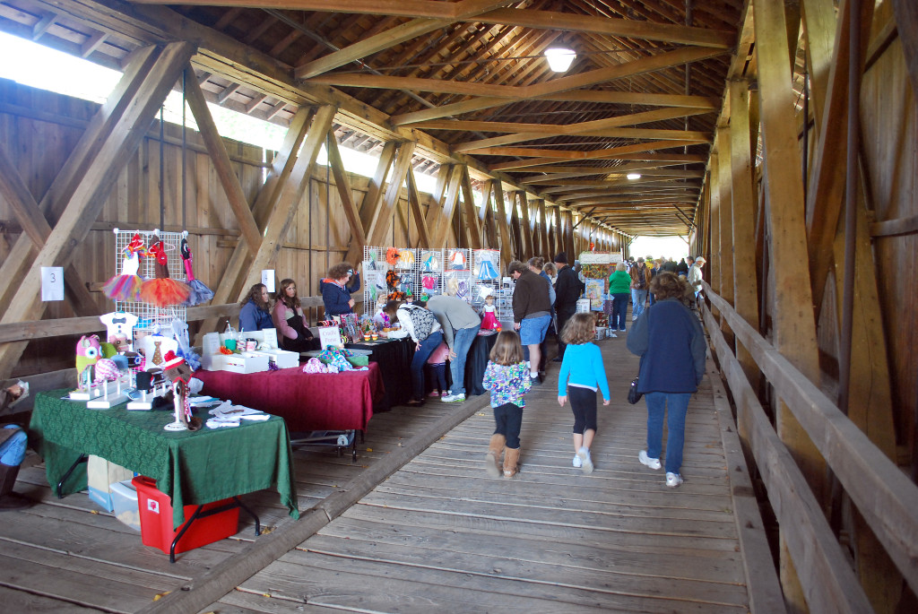 Arts and crafts vendors fill the outside and inside of Potter’s Bridge during the annual fall festival. Organizers said more than 70 vendors will attend this year’s event. (File photo by Robert Herrington)