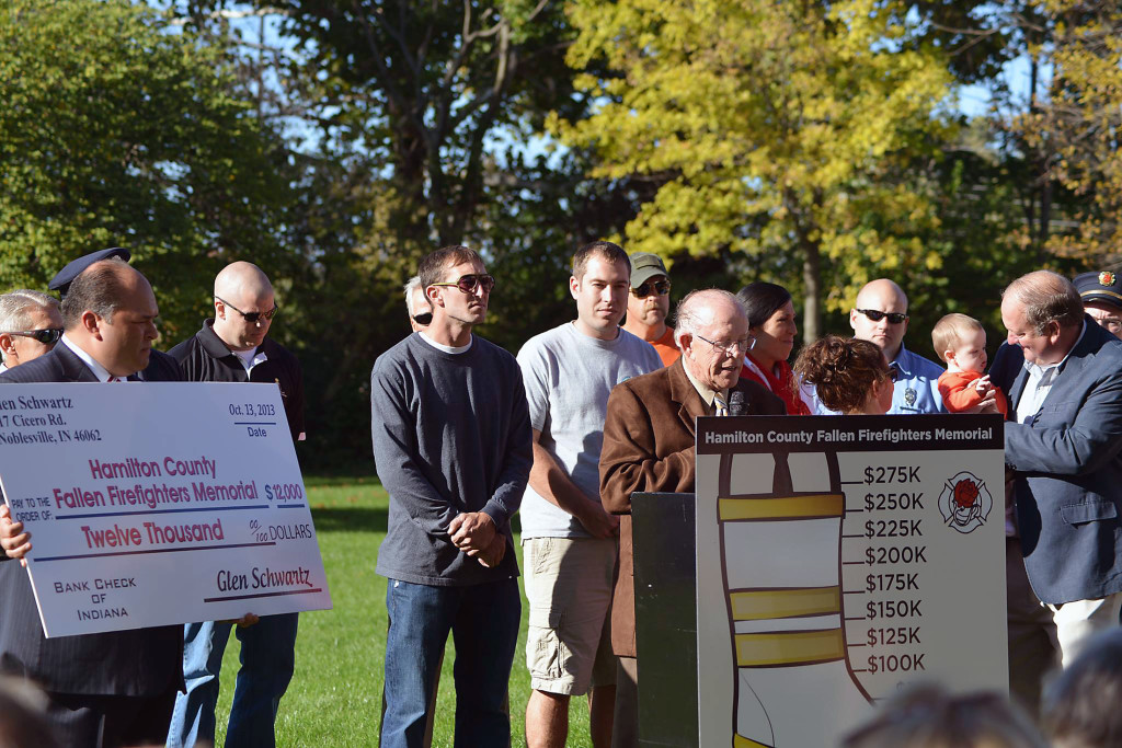 Surrounded by his family, Local 4416 President Tony Murray holds the $12,000 check presented by Glen Schwartz as he addresses the crowd on Oct. 13. (Submitted photo.)