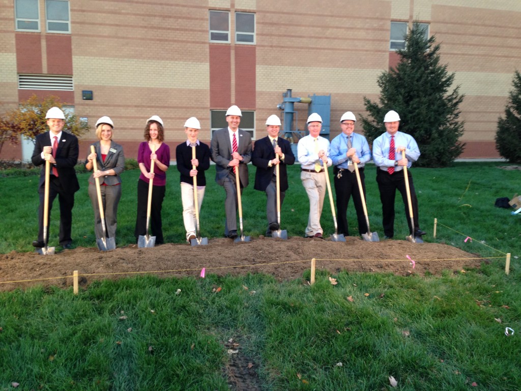 Fishers High School principal Jason Urban, 5th from left, breaks ground for the Senior Academy. He is joined by Fishers High School students and administrative staff. (Photo by Julie Roberts.)