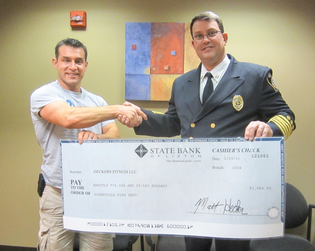 In its first year, Heckers’ Holiday Fitness challenge was able to raise more than $2,000 for the Zionsville Fire Department. Pictured here are Matt Hecker with Zionsville Fire Chief, James VanGorder.