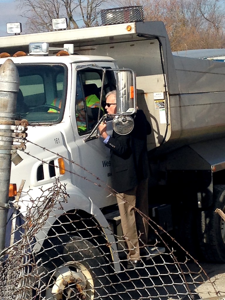 – Mayor Andy Cook talks with a Westfield public works employee as the city offered two dump trucks and a front loader to assist with storm cleanup.