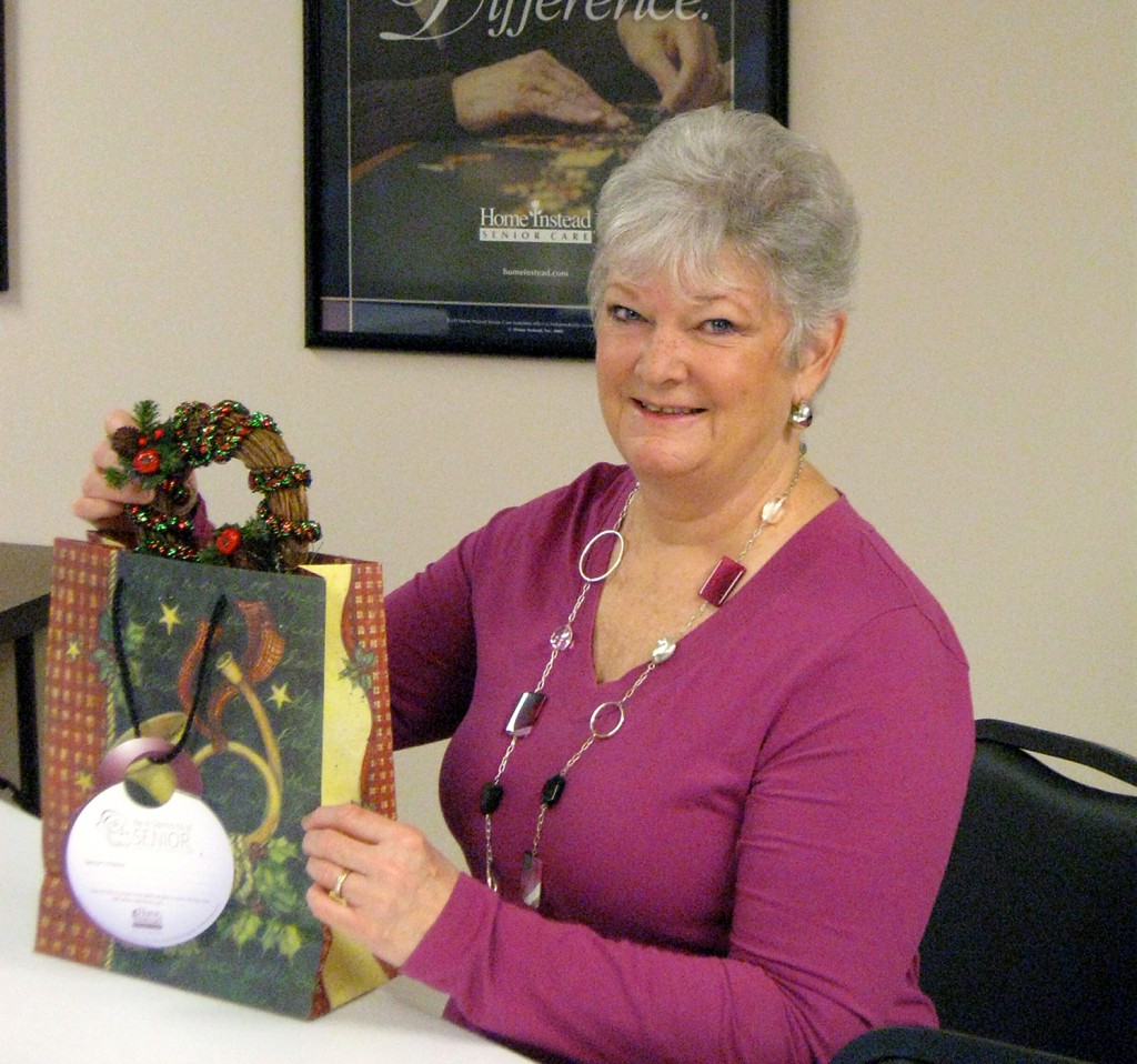 Linda Connors helps Home Instead Senior Care get a jump start on wrapping the gifts for seniors. (Submitted photo)