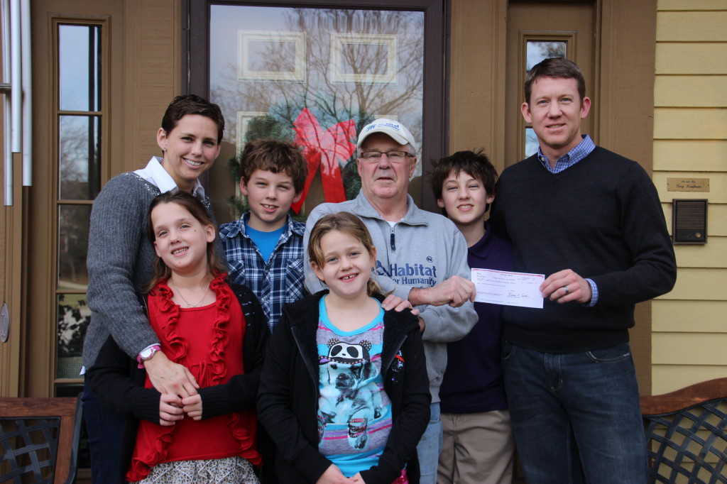 Members of the Kaufmann family present a check to Steve Furste, Executive Director of Habitat for Humanity of Boone County. From left (front row): Madeline Kaufmann and Grace Kaufmann. From left (back row): Dr. Mary Riley, Jack Kaufmann, Steve Furste, Ethan Kaufmann and Dr. Michael Kaufmann.