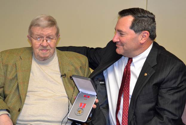 U.S. Sen. Joe Donnelly presents the Bronze Star Medal to veteran Michael Hodgson.