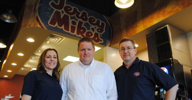 The co-owners of the new Jersey Mike’s Subs restaurant in Carmel, from left, Liz, Casey and Greg Watson hope to open two more restaurants in the area within the next year. (Staff photo)