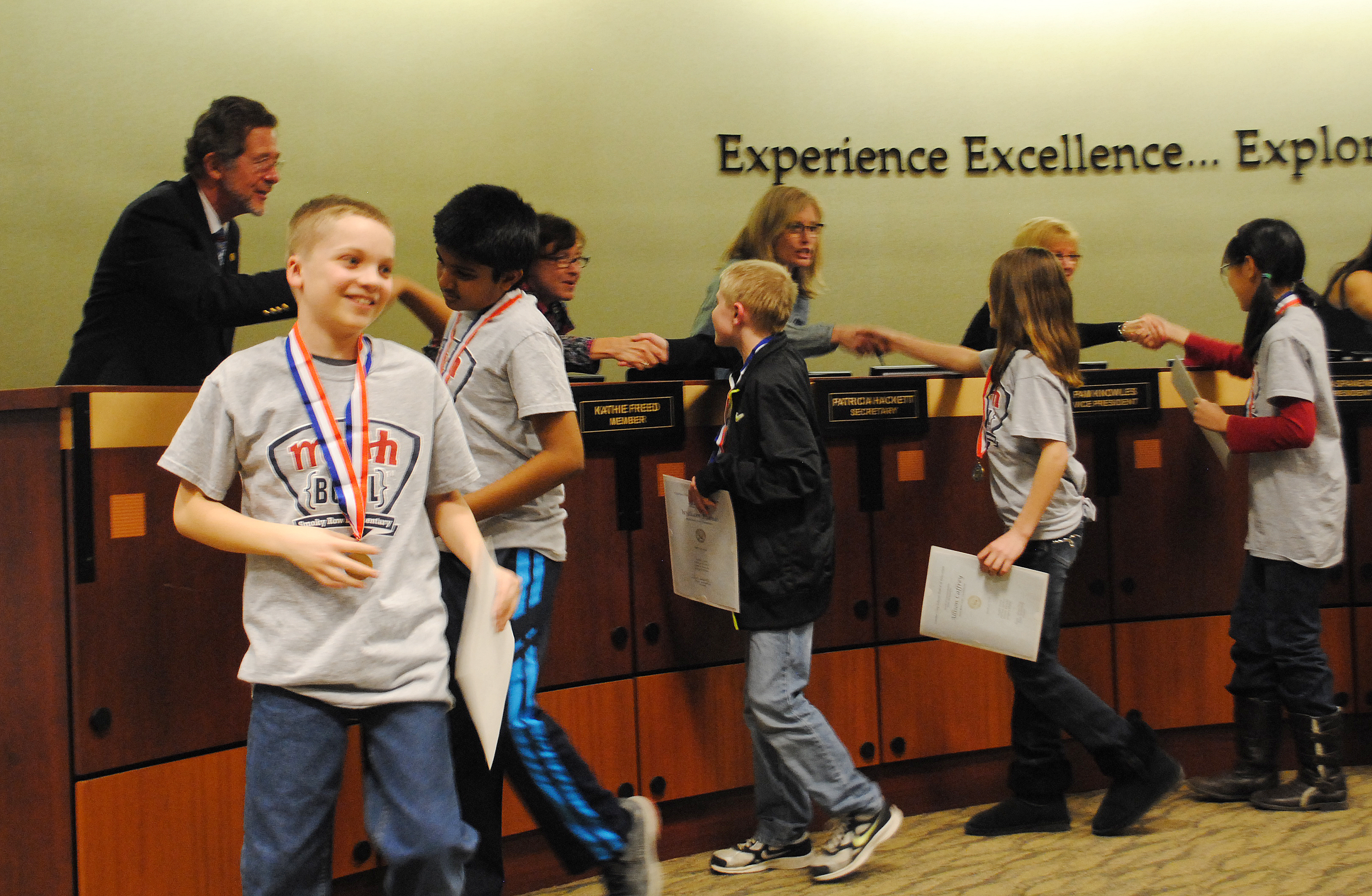 Smoky Row Elementary School students shake school board members’ hands after being recognized for winning the state Math Bowl. (Staff photo)