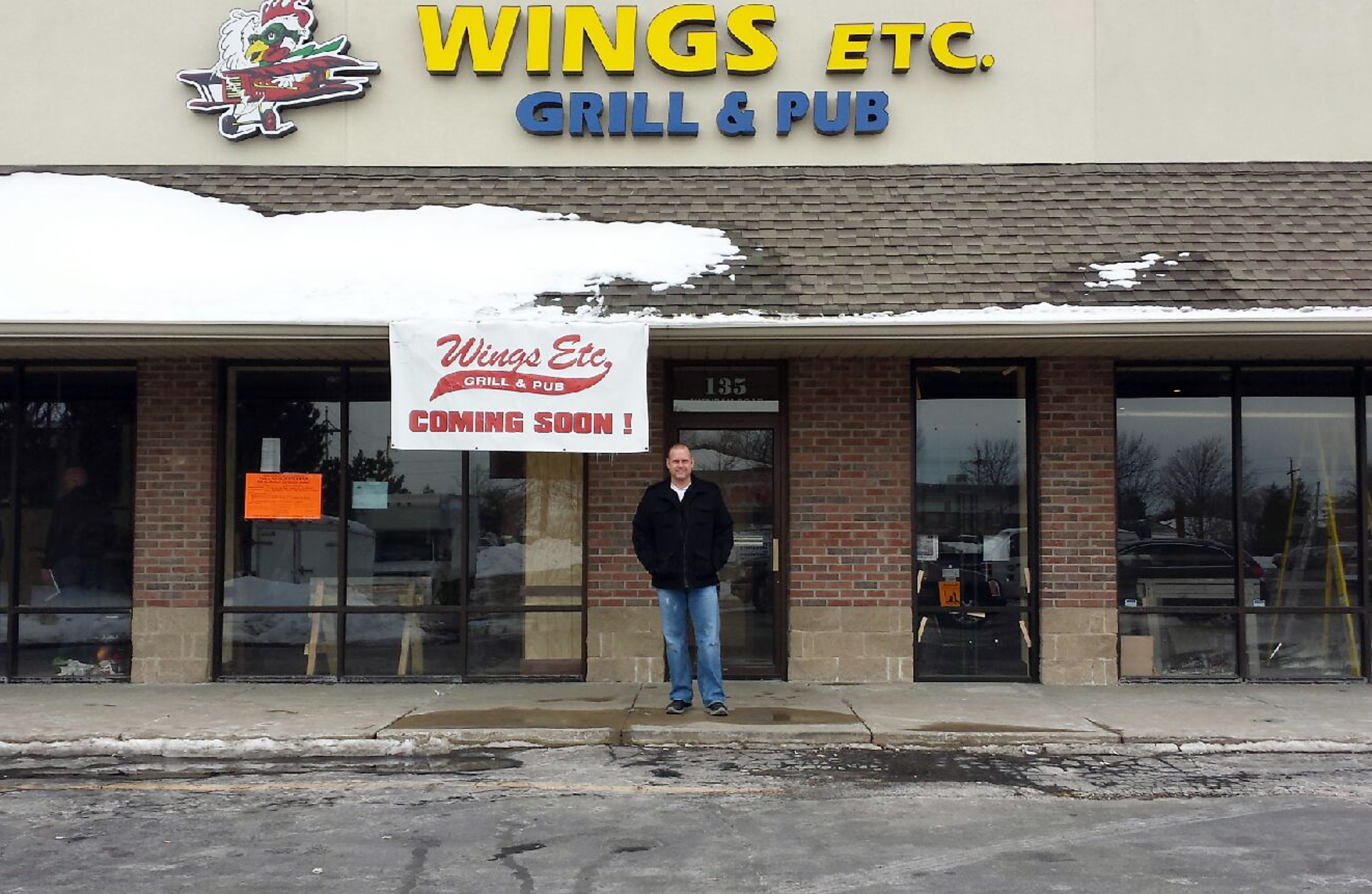 John Dompier outside his new restaurant, Wings Etc., 135 Sheridan Rd. (Photo by Kristen Yates)