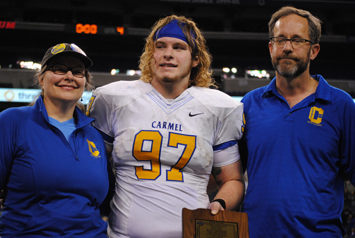 Carmel senior Vic Roe, center, won the Indiana High School Athletic Association Phil N. Eskew Mental Attitude Award after the 2013 6A championship game. (Staff photo)