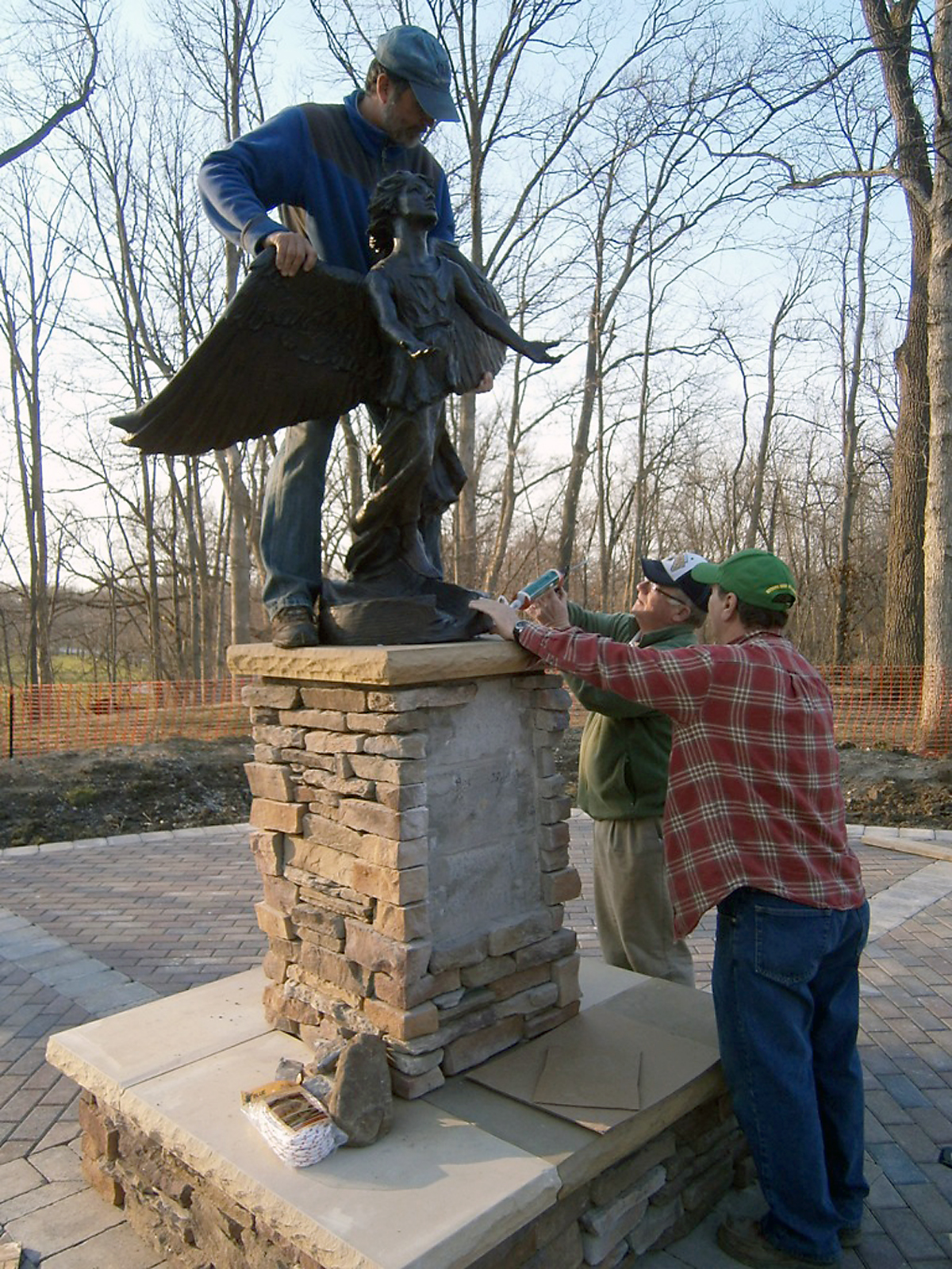 Gary Warren, Bill Eagleson and Randy Neff install the bronze Angel of Hope statue on her pedestal in Noblesville’s Forest Park. The memorial will be dedicated at 3 p.m. May 4. (Submitted photo)
