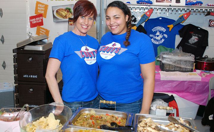 Bar manager Jewels Shrader, left, and server Chyanne Lopez provide nachos at the Chuy’s booth during the Noblesville Chamber of Commerce Taste of Noblesville event on March 25. (Staff photo by Robert Herrington)