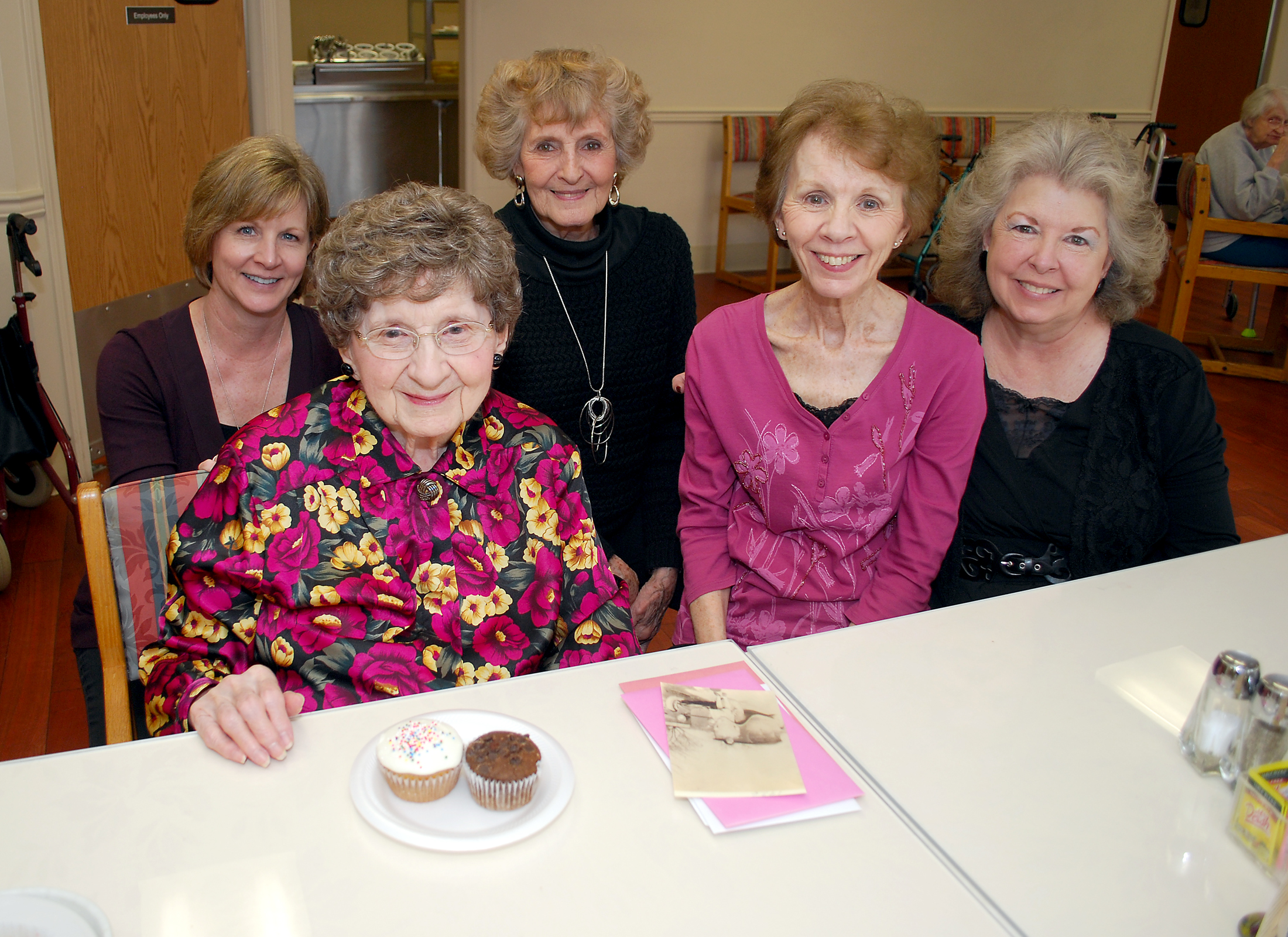 From left: Lori Nicholas, granddaughter; Lucille Robertson; Bonnie Mitchell, niece; and daughters Roberta Elliott and Sharon Sportsman celebrate Robertson’s 100th birthday at Sanders Glen Assisted Living community. (Photo by Robert Herrington)