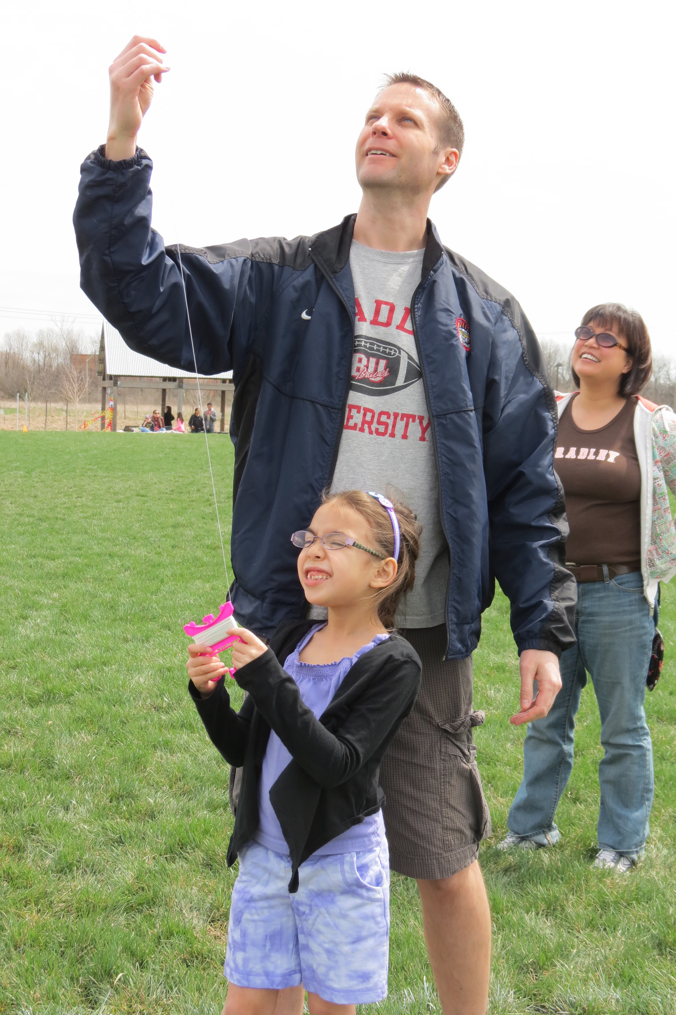 Young boys and girls do their best at flying kites during last year’s Kite Day in Mulberry Fields. This year the event will take place from 12 to 3 p.m., April 27. (Photo courtesy of Black Dog Books)