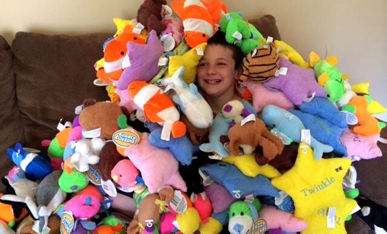 Nine-year-old Hudson Miles with the stuffed animals he donated to the Fishers Fire Department. (Submitted photo)