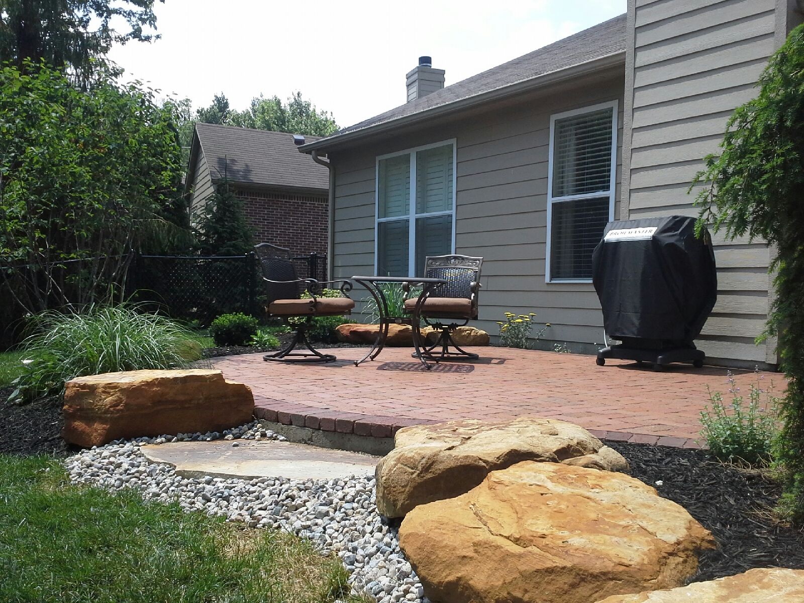 Clay pavers are a preferred material because of their rich texture and color and it marries well with the natural boulder clusters that define the beds and helps to transition the grade. (Submitted photo)
