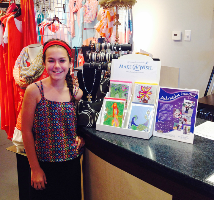 Liv Palmer, 11, at AH Collections with the Make-a-Wish Foundation cards that she designed 