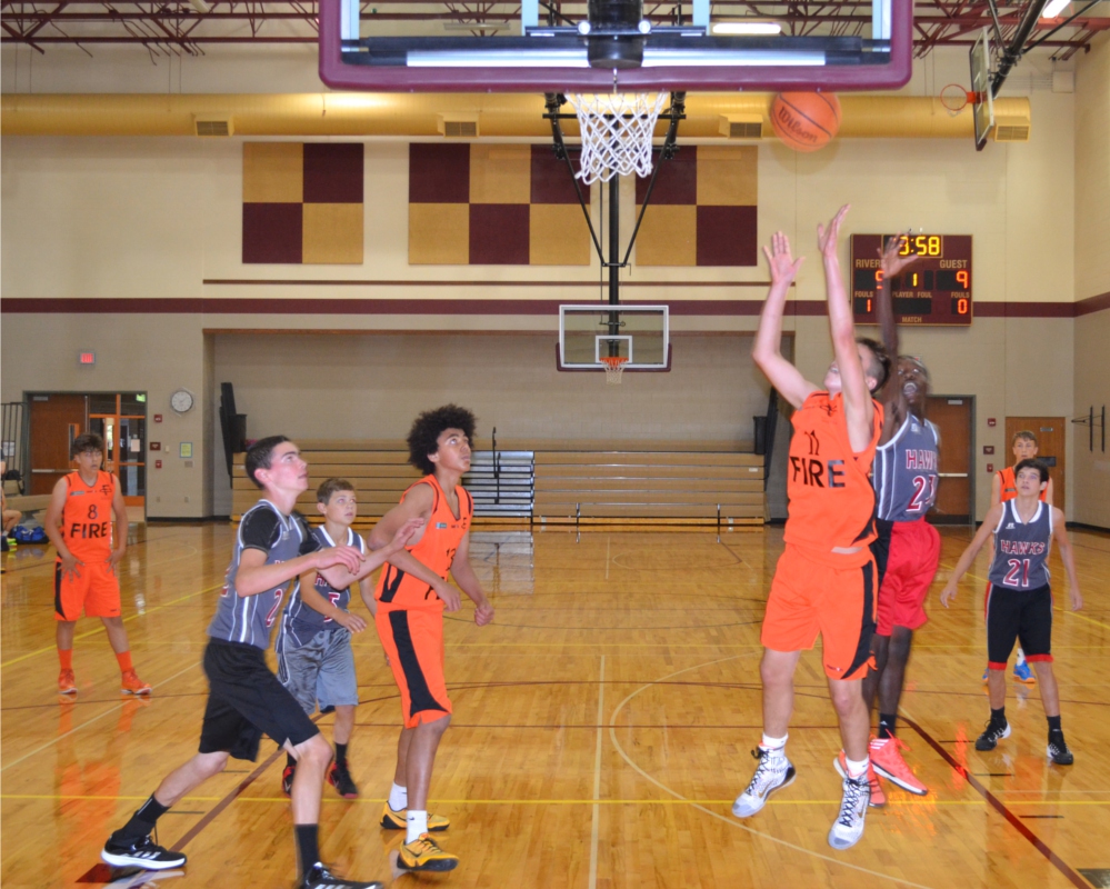 Eighth-graders from England’s Champions Academy (in orange) battle a Fishers team at Riverside Jr. High in a July 21 game. (Photo by John Cinnamon)