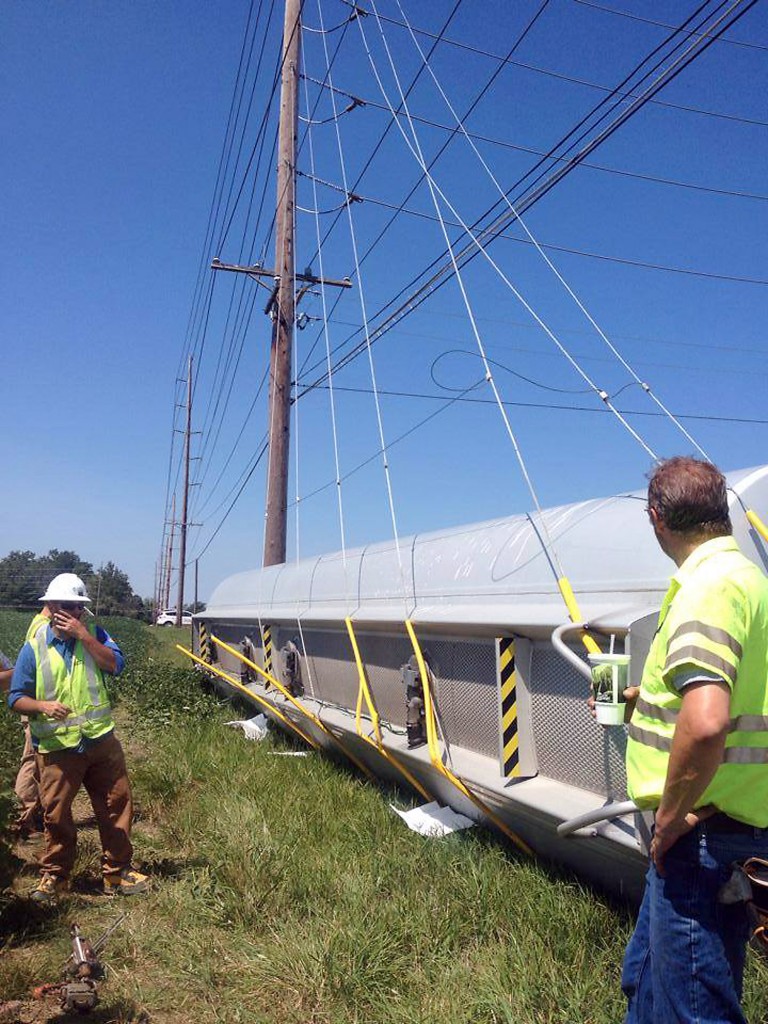 The overturned tanker trailer is braced as Duke Energy works to shut off the power so the semi can be moved on Aug. 14. Because of its location near power lines, it took crews eight hours to remove the diesel fuel tanker. (Submitted photo)
