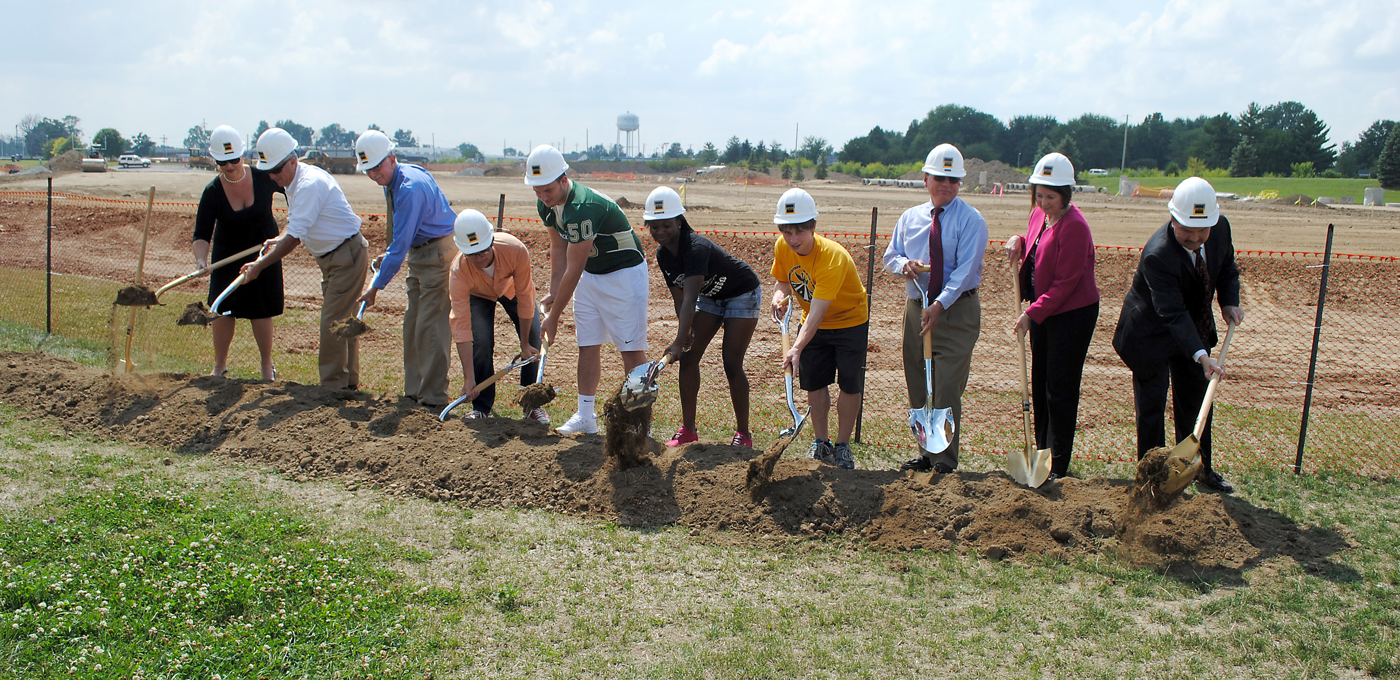 From left: Westfield High School Principal Dr. Stacy McGuire, Mayor Andy Cook, Westfield Washington Schools Supt. Dr. Mark Keen, WHS students Aaron Smith, Ryan Pape, Karen Hubbard and Johnny Crawford, Westfield City Council President Jim Ake, Riverview Health Chief Financial Officer Brenda Baker and Riverview Health COO Larry Christman break ground on the new community stadium Aug. 18. (Photo by Robert Herrington)