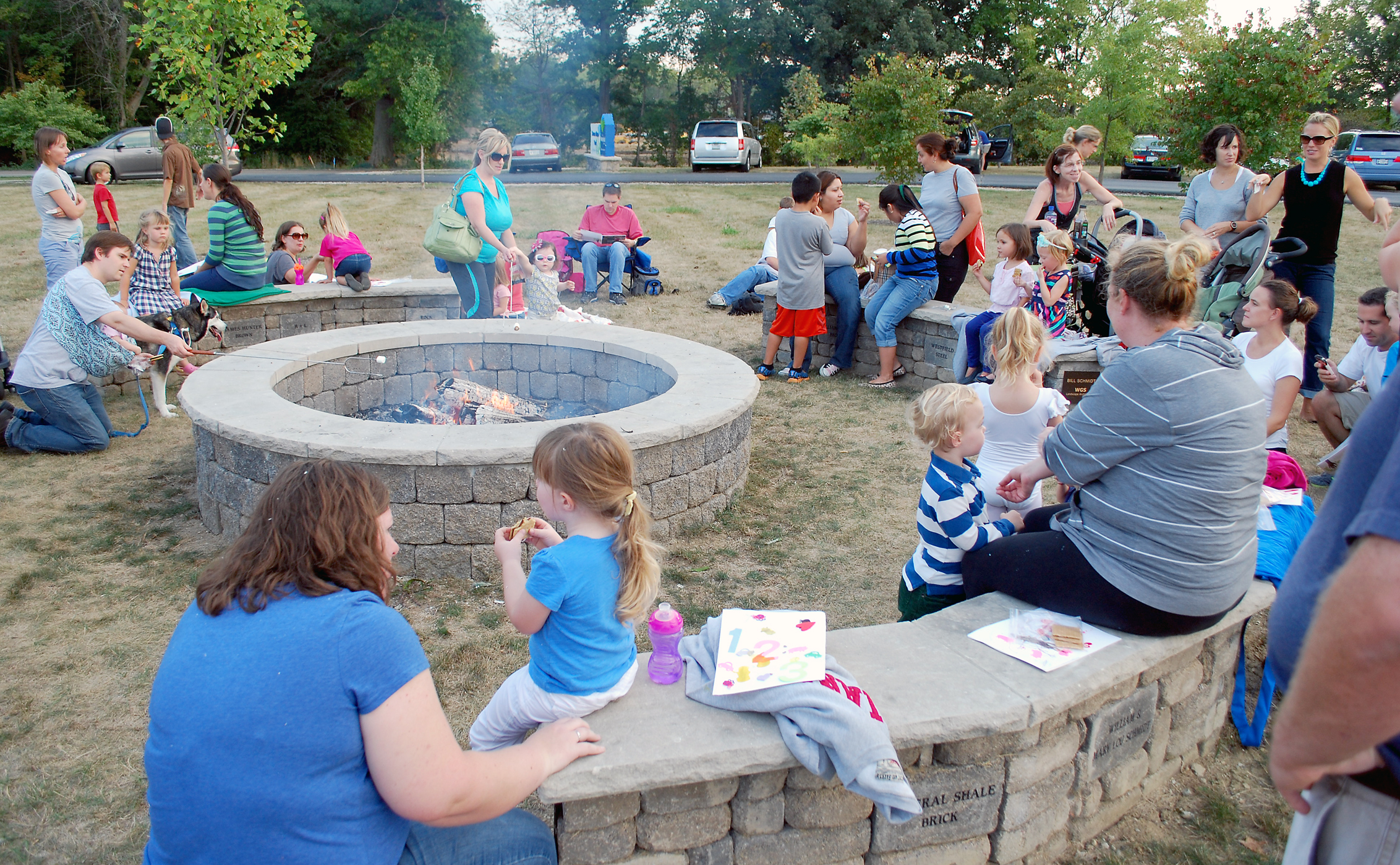 Parents and children gather around the Council Circle Fire Pit at Simon Moon Park eating s’mores before Vicki Parker’s story telling last year.