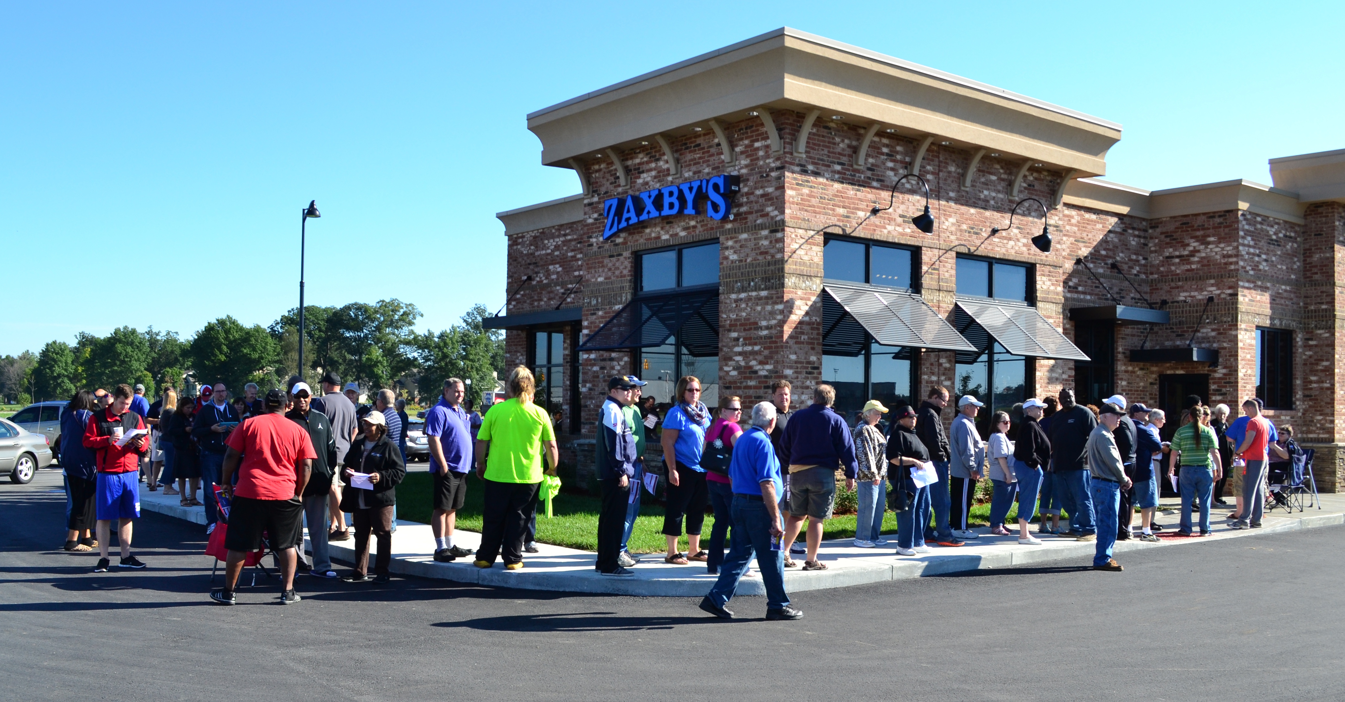 A crowd gathered outside Zaxby’s at Fishers Marketplace Sept. 8 for the grand opening and an offer of free meals for a year for the first 100 customers. (Photo by John Cinnamon)