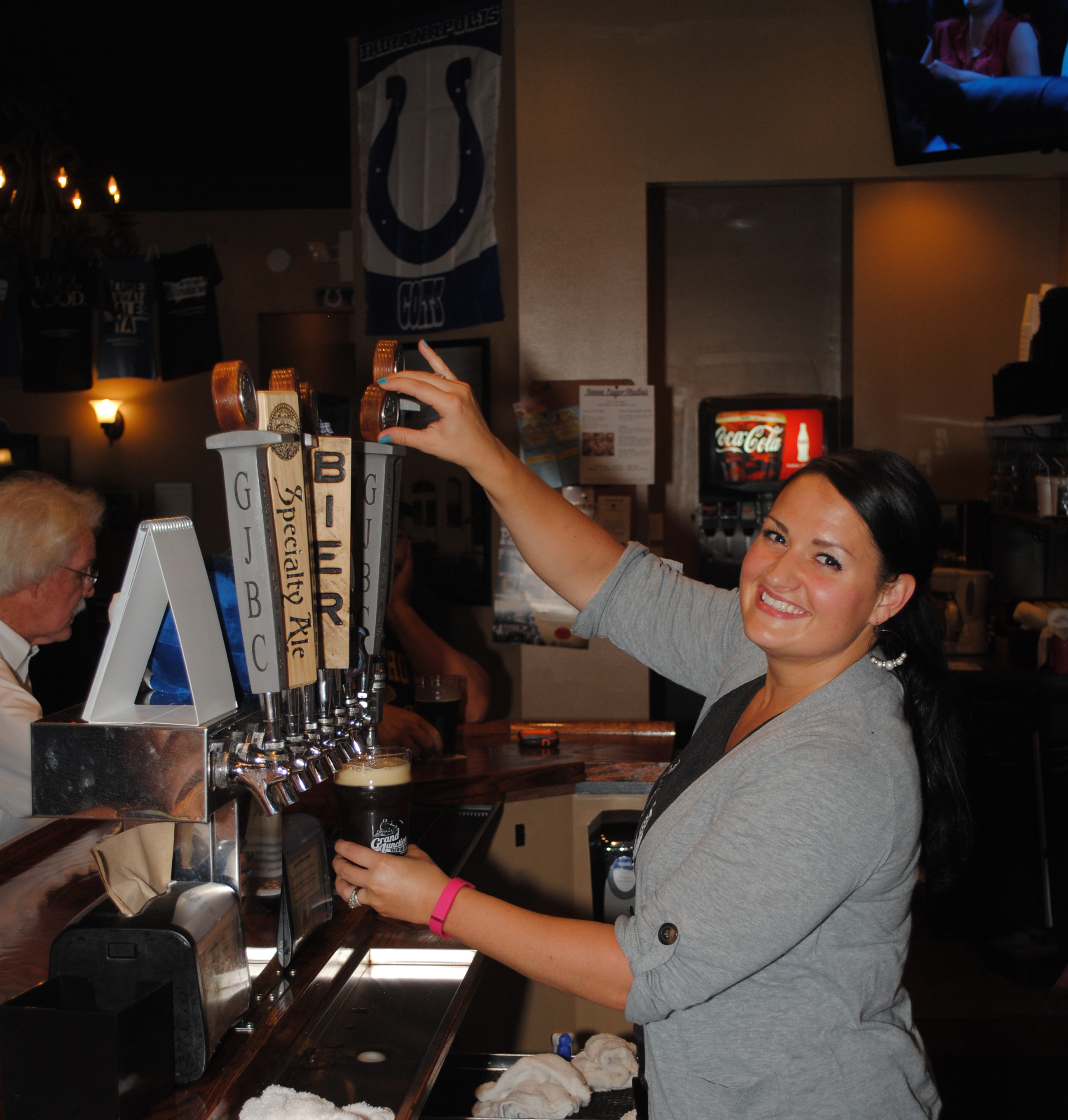 Rachel Cochran pours a pint of Westfield-produced beer at Grand Junction Brewing Co. The business, which started this spring, is the first recipient of the Spark Award since 2006. (Photo by Robert Herrington)