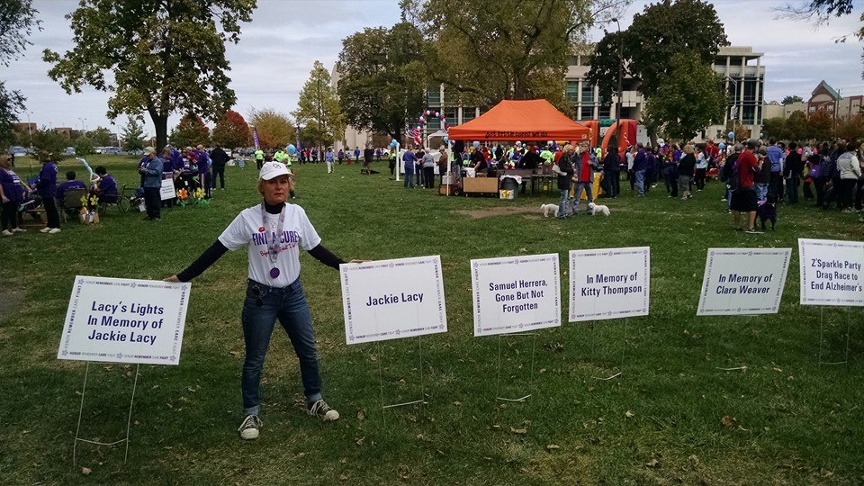 Amy Lacy, of Zionsville, stands among the Walk to End Alzheimer’s signs. (Submitted photo)