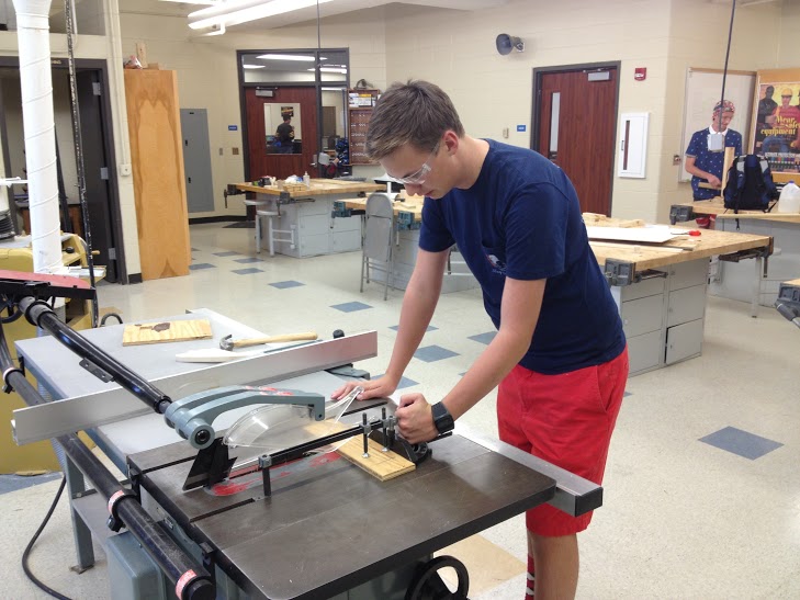 HSE senior Kendall Mason works with the table saw, building a practice game field for the robot. (Submitted photo)