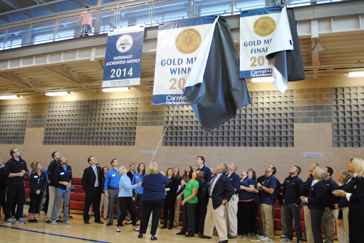 Park officials unveil new banner. (Photo by Mark Ambrogi)