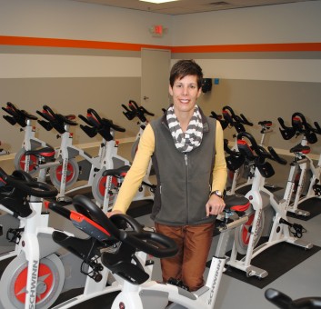 Lisa Herrmann, owner of Rally. Rock. Ride. shows the new cycling equipment in her studio. (Photo by Robert Herrington)