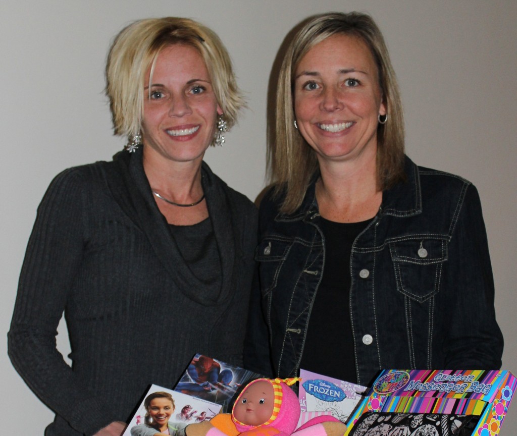 Jennifer Payne, left, and business partner Renee Ahearn with a 2014 Holiday Hands of Hope collection box.