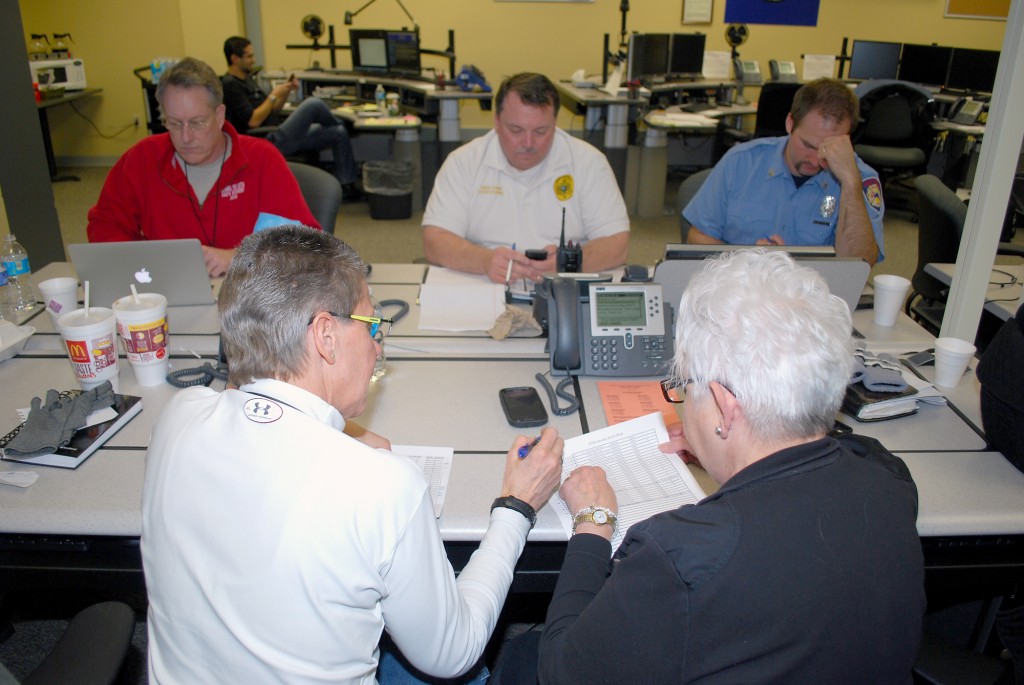 Officials work on power outage lists inside the Hamilton County Emergency Operations Center on Jan. 7. (File photo)
