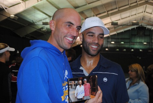 Carmel High School girls and boys tennis coach Mike Bostic gets his picture taken with James Blake holding a picture taken of the two of them when Bostic ran into Blake while attending the U.S. Open in New York. Blake earlier autographed the picture. (Photo by Mark Ambrogi)