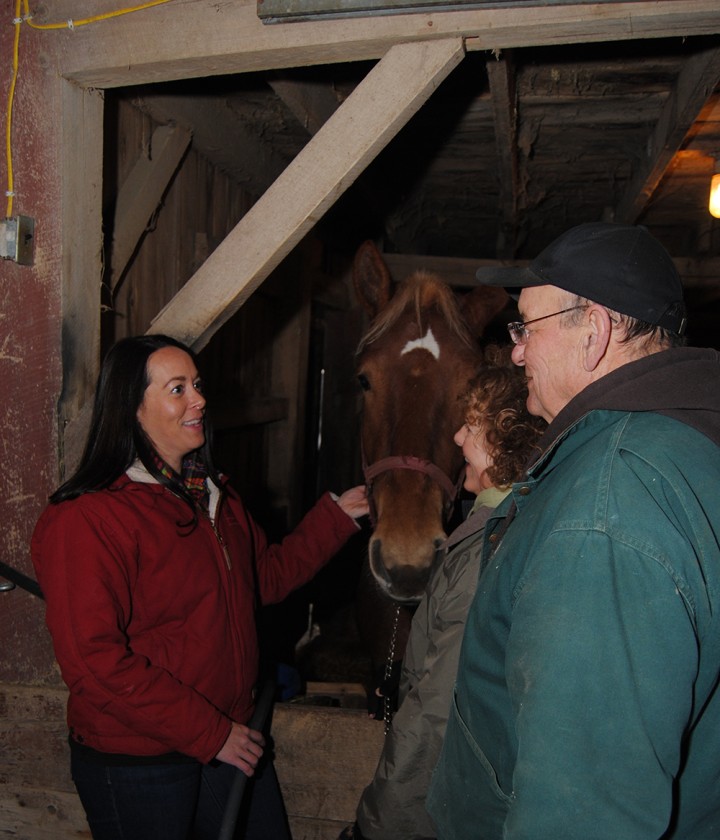 Washington Township Trustee Danielle Carey Tolan talks with her parents, Jim and Lynn Carey, on their family-farm, which has Belgium draft horses. (Photo by Robert Herrington)